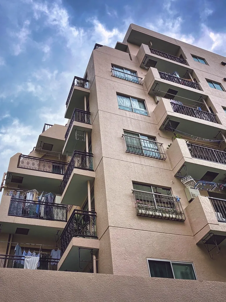 Apartment building with balconies against a blue sky