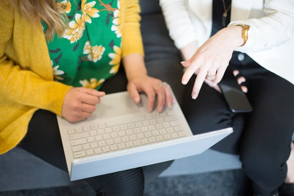 Two founders reviewing a product on a laptop